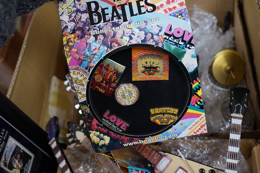 A collection of Beatles memorabilia including; models of a Beatles drum kit and eight miniature guitars and stands, each approx 25cm long, together with three boxed Corgi Beatles related models, including the Yellow Subm